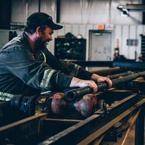 AK Casing worker inspecting casing in the shop