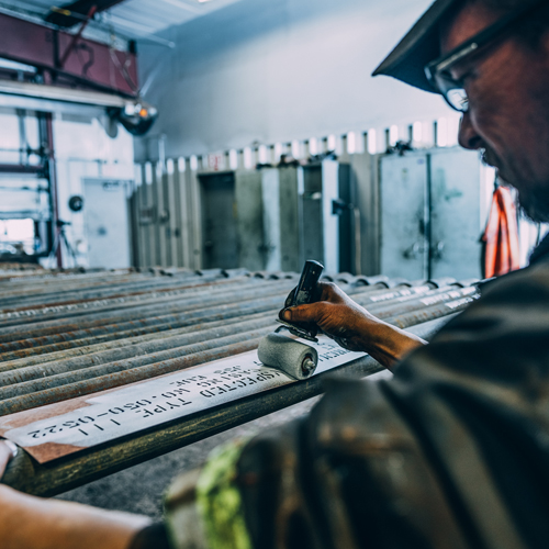 AK Casing worker marking and grading pipe
